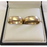 A pair of matching 9ct gold wedding bands. One size U, the other size T. Total weight approx 4.3g.