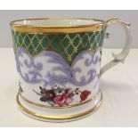 A large 19th century ceramic mug with handpainted flowers and gilt decoration.