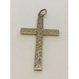 A hallmarked 9ct gold cross shaped pendant. With engraved floral decoration to front. Total weight