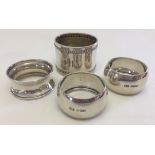 4 silver napkin rings of various designs. 3 hallmarked and one marked 800.