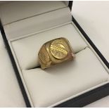 Gents heavy 18ct gold dress ring with circular engraved decoration. Size V, weight approx 13.3g