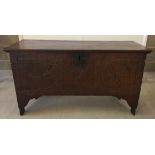 An antique oak coffer with geometric design to front. Approx 107 x 61cm.