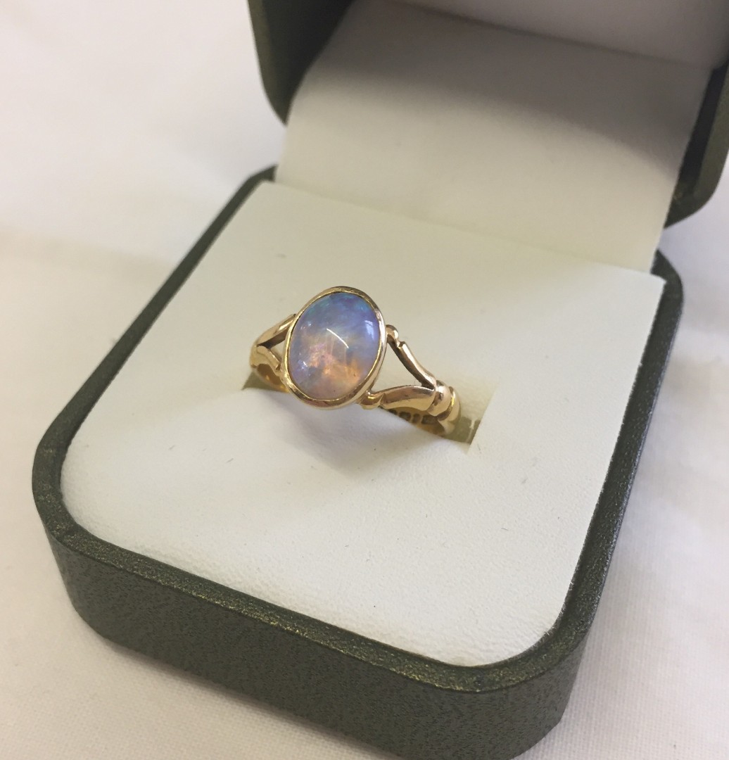 22ct gold dress ring set with an oval opal. Size N, total weight approx 4.4g