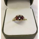 Pretty 9ct gold ring set with 3 oval garnets in a decorative mount. Size M, total weight approx 1.