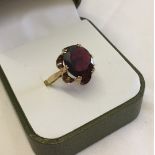 Vintage cocktail ring in 9ct gold, claw set with a large oval garnet. Size N, total weight approx