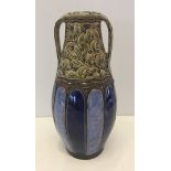 A Royal Doulton Lambeth 2 handled vase in blue & green. Size 26cm tall, inscribed AT to base.