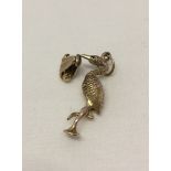 9ct gold stork with baby pendant/charm. Measures approx 3cm long, weight approx 4.4g.