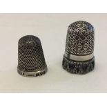 2 antique silver thimbles, one very ornate with open work skirt around the base, by Charles