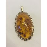 A large Baltic amber and 10k gold pendant. Approx overall size 3.5cm x 5.5cm. Bale marked 10K, amber