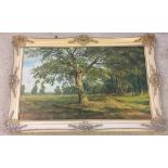 A large oil on canvas of a woodland scene - In cream & gilt frame. Approx 117 x 78cm. Signed by