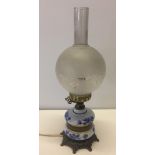 A Delft style ceramic & brass oil lamp.