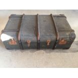 A vintage travelling trunk marked D.M.K with a quantity of leather belts and straps.