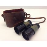 A leather cased set of binoculars.