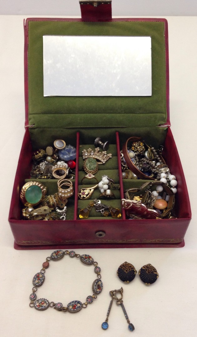 A red box containing an assortment of vintage costume jewellery including micro mosaic.