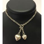 A 925 silver chain with heart shaped pendants.