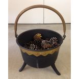 Vintage cast iron cauldron with 3 legs and brass handle.