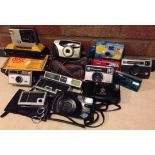 A collection of 14 vintage cameras.
