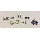 A collection of 7 pairs of assorted silver earrings.