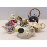 A collection of 6 ceramic teapots.
