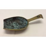 A small brass metal sweet scoop.