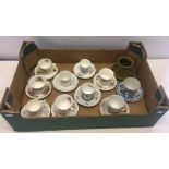 A collection of 11 ceramic cups & saucers.