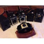 Collection of 5 Kodak box brownie cameras and a Kodak brownie 727 camera.