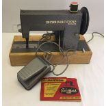 A vintage Universal Sewmaid sewing machine.