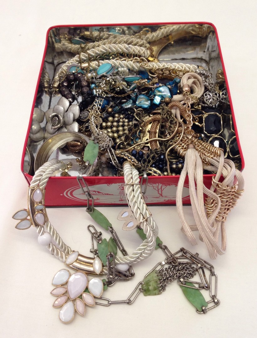 A box containing a collection of modern costume jewellery necklaces.