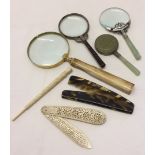 3 magnifying glasses together with a hand mirror, ivory page turner and carved cigarette holder.