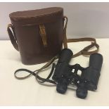 A pair of Coe of Norwich binoculars in leather case.