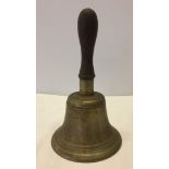 A vintage wooden handled school bell.
