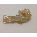 A vintage mother of pearl shell bird in the hand brooch.