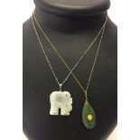 A jade elephant pendant on a silver chain. Together with a jade pendant on a gold plated chain.