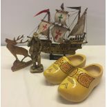 4 vintage wooden items. To include a pair of cloggs and a model of the 'Santa Maria' ship.