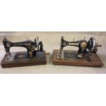 2 vintage hand sewing machines.