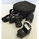 A Canon T70 35mm camera with a Panagor 80-200mm telephoto lens and Cobra flash gun in soft case.
