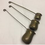 3 long handled brass measures whisky, rum and brandy.