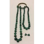 A collection of malachite jewellery.