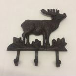 A reproduction cast iron coat hook with stag motif.