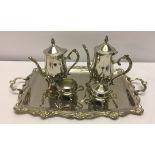 A silver plated tea set on a tray.