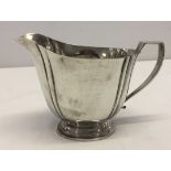 A silver milk jug.