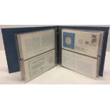 A folder of United Nations first day coin covers with first edition sterling silver proof coins.