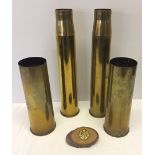 4 WW2 shell cases together with an RAF cap badge.