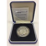 A boxed & cased silver proof millenium 5 pound coin.