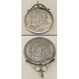 A 1921 American Morgan silver dollar set in a silver necklace mount.