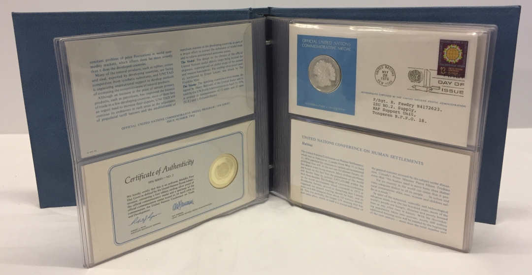 A folder of United Nations first day coin covers with first edition sterling silver proof coins.