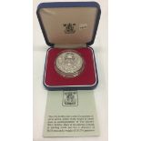 A boxed & cased silver proof crown coin.