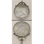 A 1922 American Peace silver dollar set in silver necklace mount.