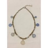 A silver and chalcedony necklace.