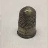 A silver thimble.